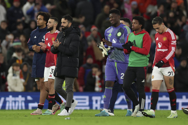 Ruben Amorim dan sejumlah pemain Manchester United menghampiri penonton usai gagal meraih kemenangan melawan Newcastle United di Old Trafford, Manchester, Inggris, Senin (30/12/2024). Foto: Phil Noble/Reuters