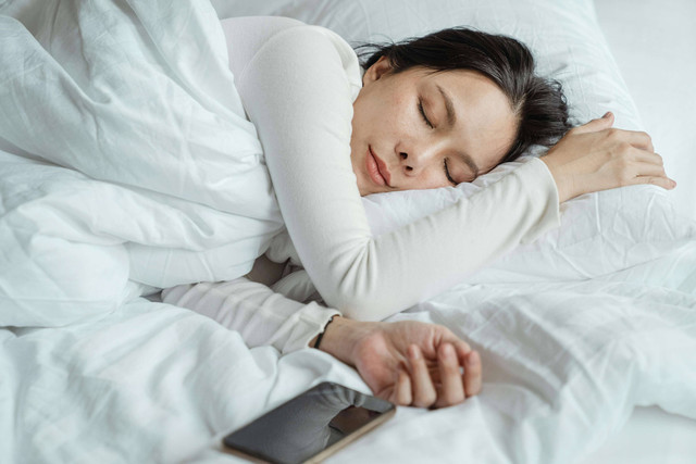 Subiyanto, K. Woman sleeping in bed near smartphone [Photograph]. Pexels.