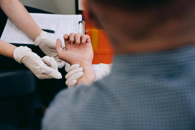 Photo by Mikhail Nilov from Pexels: https://www.pexels.com/photo/close-up-of-paramedics-holding-hand-of-a-patient-8943097/