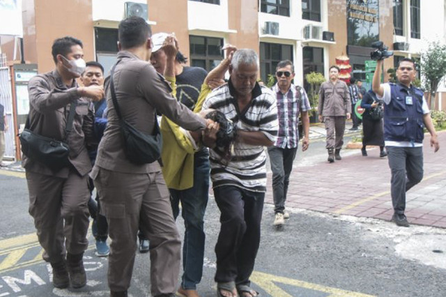 Petugas jaksa bersama warga membopong ibu kandung penyandang tunadaksa I Wayan Agus Suartama yang jatuh pingsan usai mendampingi anak kandungnya selaku terdakwa dalam perkara pelecehan seksual sidang perdana di Pengadilan Negeri Mataram, NTB, Kamis. Foto: Dhimas Budi Pratama/ANTARA Foto