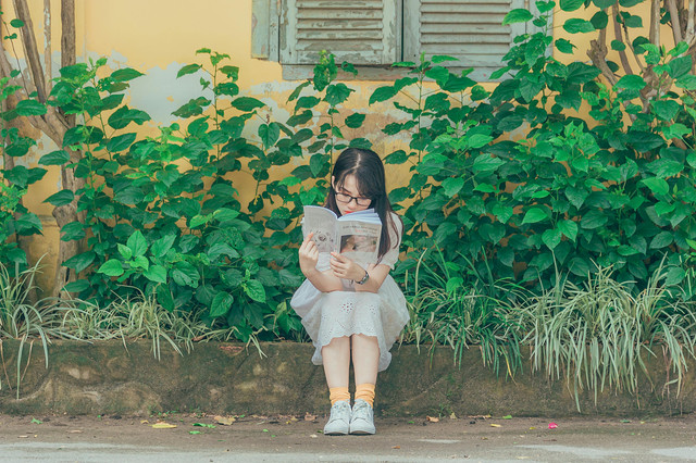 Photo by Min An: https://www.pexels.com/photo/woman-wearing-white-dress-reading-book-1196338/