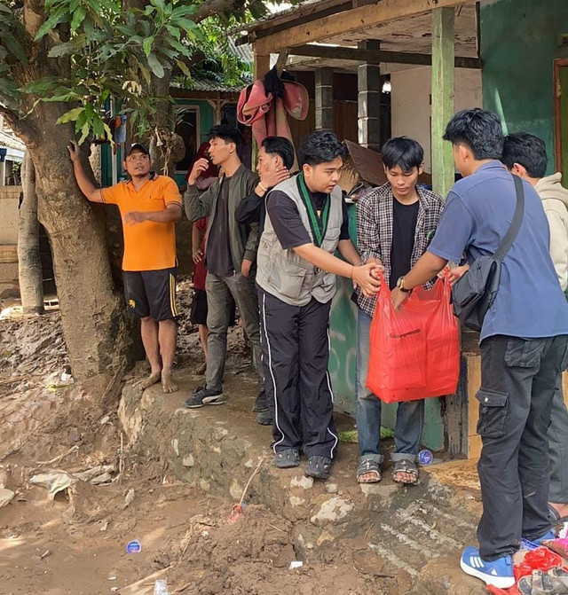 HMI Komisariat Pertanian Unila saat memberikan bantuan kepada warga terdampak banjir. | Foto: Istimewa