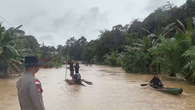 Banjir merendam akses jalan lintas negara Malaysia-Indonesia di Beduai Sanggau. Foto: Dok. Satlantas Polres Sanggau