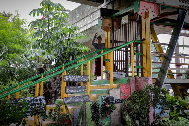 Seorang warga memanjat pagar yang yang menutup jembatan penyeberangan orang di kawasan Rawajati, Kalibata, Jakarta, Senin (3/2/2025).  Foto: Jamal Ramadhan/kumparan