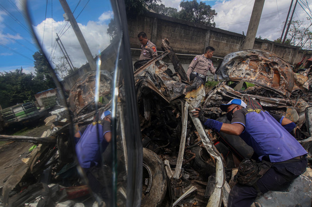 Polisi mengidentifikasi bangkai kendaraan roda empat yang ringsek usai terlibat kecelakaan beruntun Gerbang Tol Ciawi 2, di Unit Laka Polresta Bogor Kota, Bogor Selatan, Kota Bogor, Jawa Barat, Rabu (5/2/2025). Foto: Yulius Satria Wijaya/ANTARA FOTO