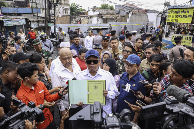 Menteri Agraria dan Tata Ruang (ATR)/Kepala Badan Pertanahan Nasional (BPN) Nusron Wahid menunjukkan sertifikat usai meninjau salah satu lahan sengketa yang sudah digusur di kawasan Tambun Selatan, Kabupaten Bekasi, Jawa Barat, Jumat (7/2/2025). Foto: Dhemas Reviyanto/ANTARA FOTO