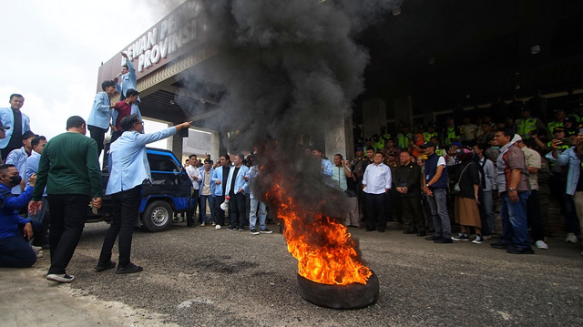 Aksi demo mahasiswa bertajuk Indonesia Gelap dengan membakar ban di depan Gedung DPRD Sumsel, Kamis (20/2) Foto: ary/urban id