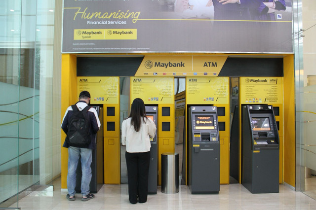 Nasabah saat mengambil uang di mesin ATM Maybank Indonesia. Foto: Dok. Maybank Indonesia