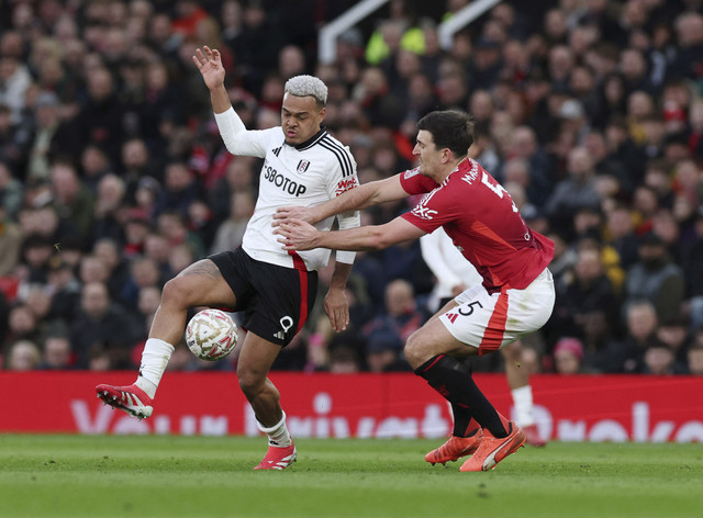 Pemain Fulham Rodrigo Muniz beraksi dengan pemain Manchester United Harry Maguire pada pertandingan Piala FA antara Manchester United vs Fulham di Old Trafford, Manchester, Inggris, Minggu (2/3/2025). Foto: Phil Noble/REUTERS