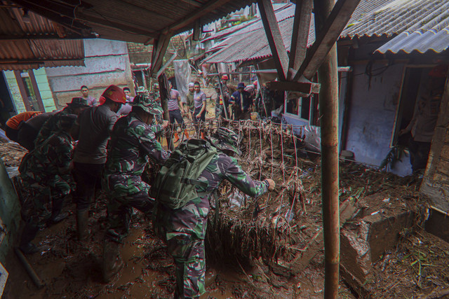 Personel TNI/Polri membersihkan material sisa banjir bandang di Kampung Pensiunan, Desa Tugu Selatan, Cisarua, Kabupaten Bogor, Jawa Barat, Senin (3/3/2025). Foto: Yulius Satria Wijaya/ANTARA FOTO