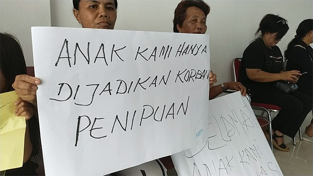 Keluarga korban TPPO di Kamboja membentangkan poster saat berada di kantor DPRD Sulawesi Utara. Mereka meminta agar lembaga perwakilan rakyat itu mencarikan solusi pemulangan keluarga mereka dari Kamboja.