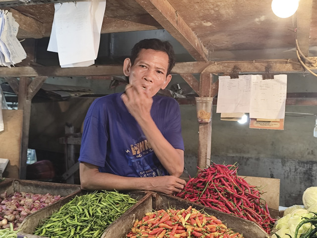 Pedagang sayur di Pasar Senen, Yusuf di lapak dagangannya, Selasa (18/3/2025). Foto: Widya Islamiati/kumparan