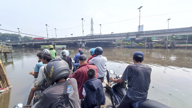 Transportasi perahu eretan untuk menyeberang Kali Cagak yang ada di kawasan Penjaringan, Jakarta Utara, Sabtu (3/5/2025). Foto: Thomas Bosco/kumparan