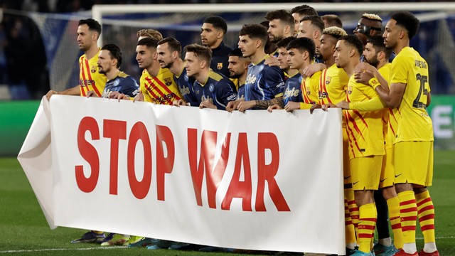 Para pemain Napoli dan FC Barcelona memasang spanduk 'Stop War' sebelum pertandingan di Stadio Diego Armando Maradona, Naples, Italia. Foto: Ciro De Luca/Reuters