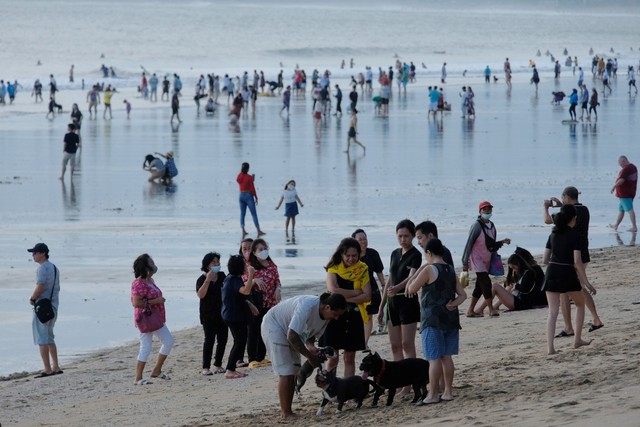 Wisatawan menikmati liburan Hari Raya Idul Fitri 1443 H di Pantai Kuta, Badung, Bali, Senin (2/5/2022). Foto: Nyoman Hendra Wibowo/Antara Foto