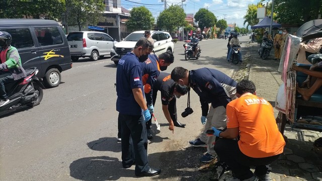 Petugas melakukan olah TKP di lokasi seorang pria berinisial D (18) diduga disabet gir oleh orang tak dikenal hingga tewas di Jalan Gedongkuning, Kota Yogyakarta. Foto: Arfiansyah Panji Purnandaru/kumparan