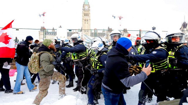 Polisi Kanada maju ke arah pemrotes di depan Parliament Hill, di Ottawa, Ontario, Kanada, Sabtu (19/2/2022). Foto: Patrick doyle/REUTERS