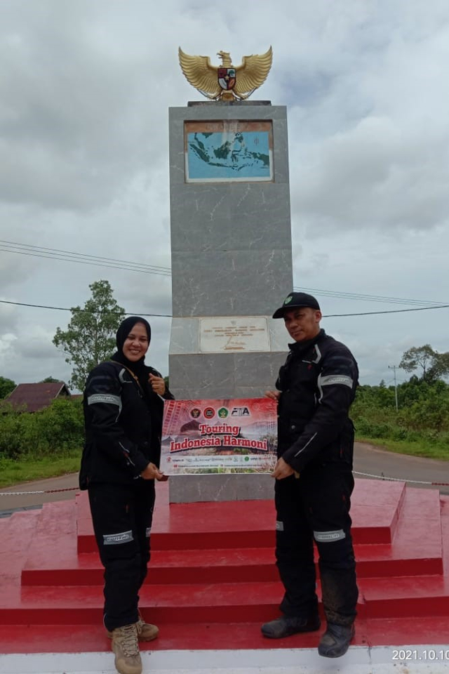 Ketua FKPT Aceh bersama istri berfoto di Tugu Kembaran Sabang Merauke di Distrik Sota, Merauke, Papua, dalam kegiatan Touring Indonesia Harmoni. Foto: Kiriman Mukhlisuddin untuk acehkini
