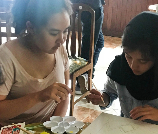 Bianca Sada (kiri) saat mengajari anak-anak di pengungsian melukis. Foto: Istimewa
