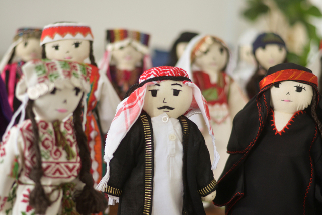 Boneka mengenakan kostum tradisional Yordania dan Palestina ditampilkan di Amman, Yordania. Foto: Muath Freij/REUTERS