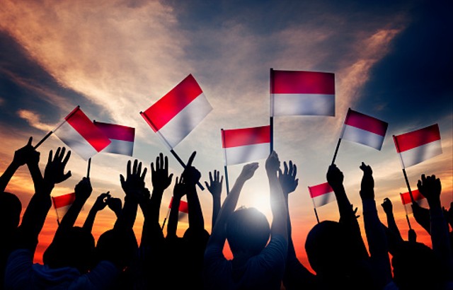 group of people waving the flag of Indonesia-pixabay