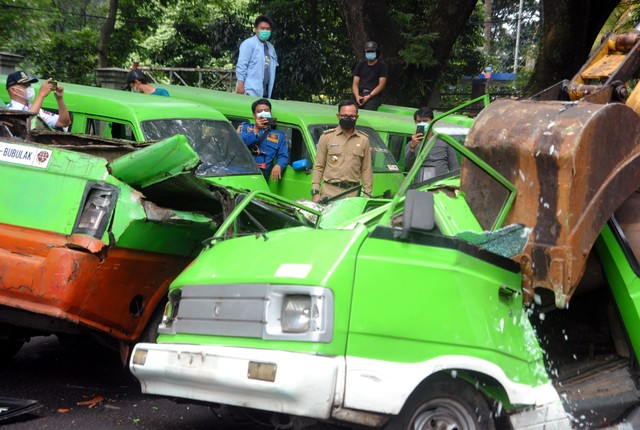 Wali Kota Bogor Bima Arya (tengah) menyaksikan penghancuran mobil angkutan kota (angkot) di halaman GOR Pajajaran, Kota Bogor, Jawa Barat, Senin (1/11/2021). Foto: Arif Firmansyah/Antara Foto
