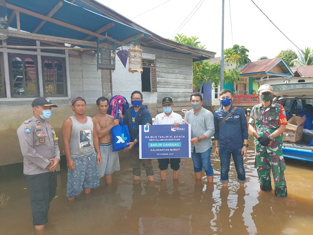 Karyawan XL Axiata menyerahkan bantuan untuk korban banjir di Sanggau. Foto: Dok. XL Axiata