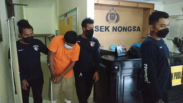 Lahunudi alias Udin (39) saat digiring polisi. Foto: Zalfirega/kepripedia.com.