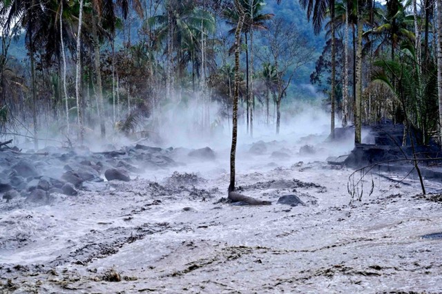 Kepulan asap menyelimuti area yang terendam banjir lahar hujan Gunung Semeru di Kamar Kajang, Candipuro, Lumajang, Jawa Timur, Kamis (16/12/2021). Foto: Budi Candra Setya/Antara Foto