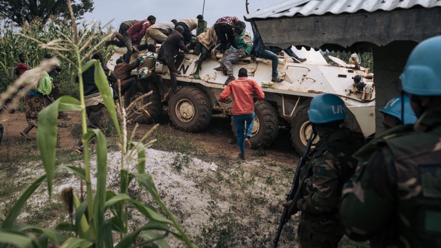 Relawan Palang Merah naik ke kendaraan lapis baja misi Perserikatan Bangsa-Bangsa di DR Kongo (MONUSCO) untuk melindungi diri dari peluru selama serangan oleh milisi Codeco. Foto: Alexis Huguet / AFP