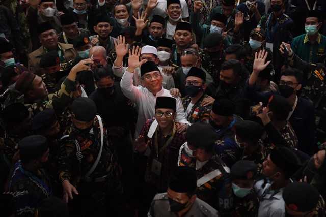 Ketua Umum PBNU terpilih Yahya Cholil Staquf (tengah) melambaikan tangan usai pemilihan Ketua Umum PBNU pada Muktamar Nahdlatul Ulama (NU) ke-34 di Universitas Lampung Foto: ANTARA FOTO/Hafidz Mubarak A
