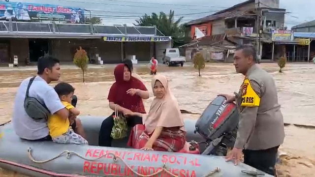 KAPOLRES Rokan Hulu, Riau, AKBP Eko Wimpiyanto Hardjito saat mengevakuasi ibu hendak melahirkan yang sudah bukaan 2 dari rumahnya menuju praktik bidan, Sabtu (1/1/2022), di Desa Babussalam, Rambah. 