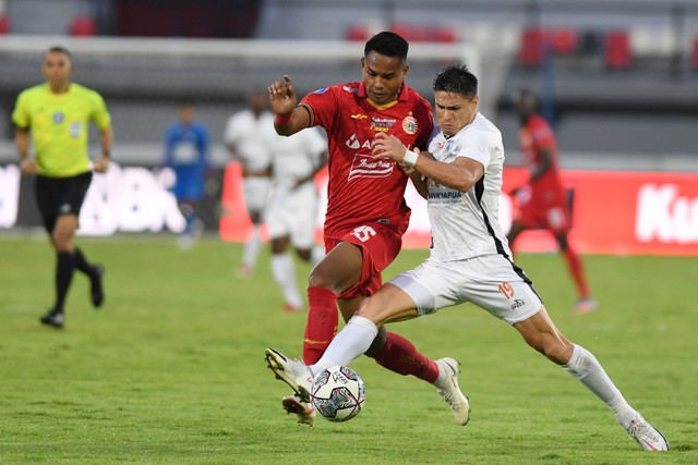 Pemain Persipura Fergonzi duel dengan pemain Persija Jakarta Ikhwan Ciptady dalam pertandingan sepak bola Liga 1 di Stadion I Wayan Dipta, Gianyar Bali, Selasa (11/1/2022). Foto: Nyoman Budhiana/Antara Foto