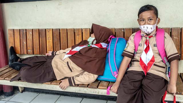 Siswa Sekolah Dasar 15 Pagi Mangga Besar menunggu jemputan orang tua usai mengikuti kegiatan belajar mengajar tatap muka di Jakarta, Rabu (19/1/2022). Foto: Muhammad Adimaja/ANTARA FOTO