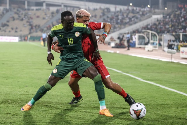 Pemain Senegal Sadio Mane beraksi dengan pemain Equatorial Guinea Iban Salvador Edu pada perempat final Piala Afrika (CAN) 2021 di Stade Ahmadou Ahidjo di Yaounde, Kamerun, Minggu (30/1/2022). Foto: Kenzo Tribouillard/AFP