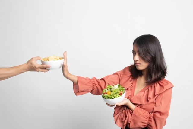 Ilustrasi wanita menolak mengonsumsi makanan dengan kandungan lemak jahat. Foto: Shutterstock.com
