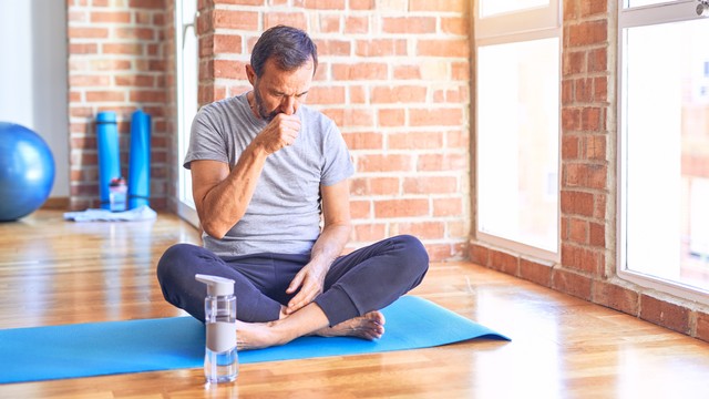 Ilustrasi pria batuk saat olahraga yoga. Foto: Krakenimages/Shutterstock