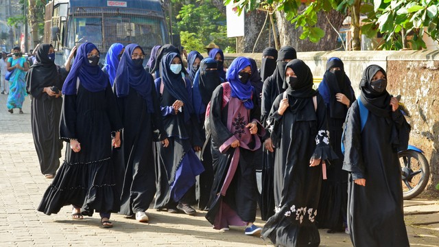 Mahasiswa perguruan tinggi Pra-Universitas pemerintah di kota Kundapur yang mengenakan jilbab tiba di kampus mereka di distrik Udupi di negara bagian Karnataka, India, Senin (7/2/2022). Foto: Dinesh Rayappana Matt/AFP 