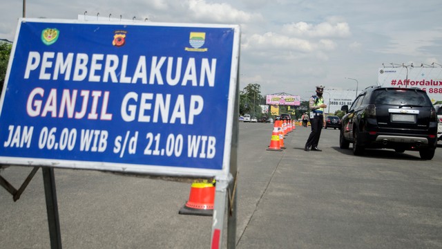 Petugas aparat gabungan melakukan penertiban penerapan ganjil-genap bagi kendaraan di Gerbang keluar Tol Pasteur, Bandung, Jawa Barat, Jumat (11/2/2022). Foto: Novrian Arbi/ANTARA FOTO