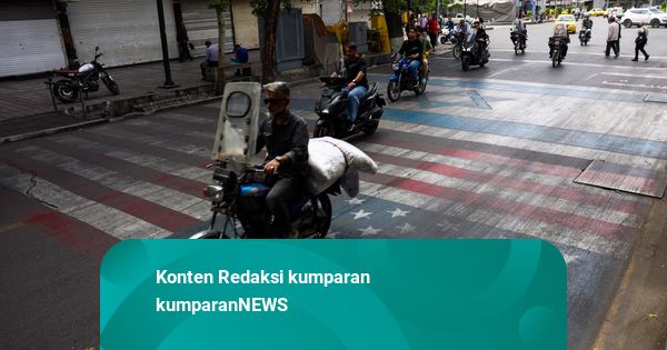 Foto: Warga Teheran Injak Gambar Bendera AS dan Israel